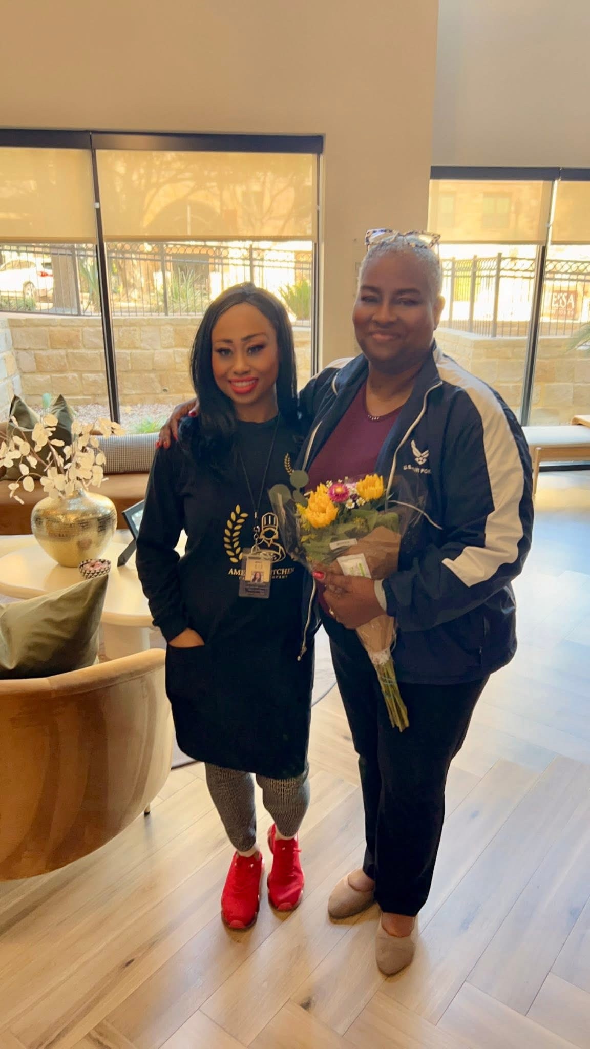 Chef Amelia receiving flowers with a customer at Customer Appreciation Day