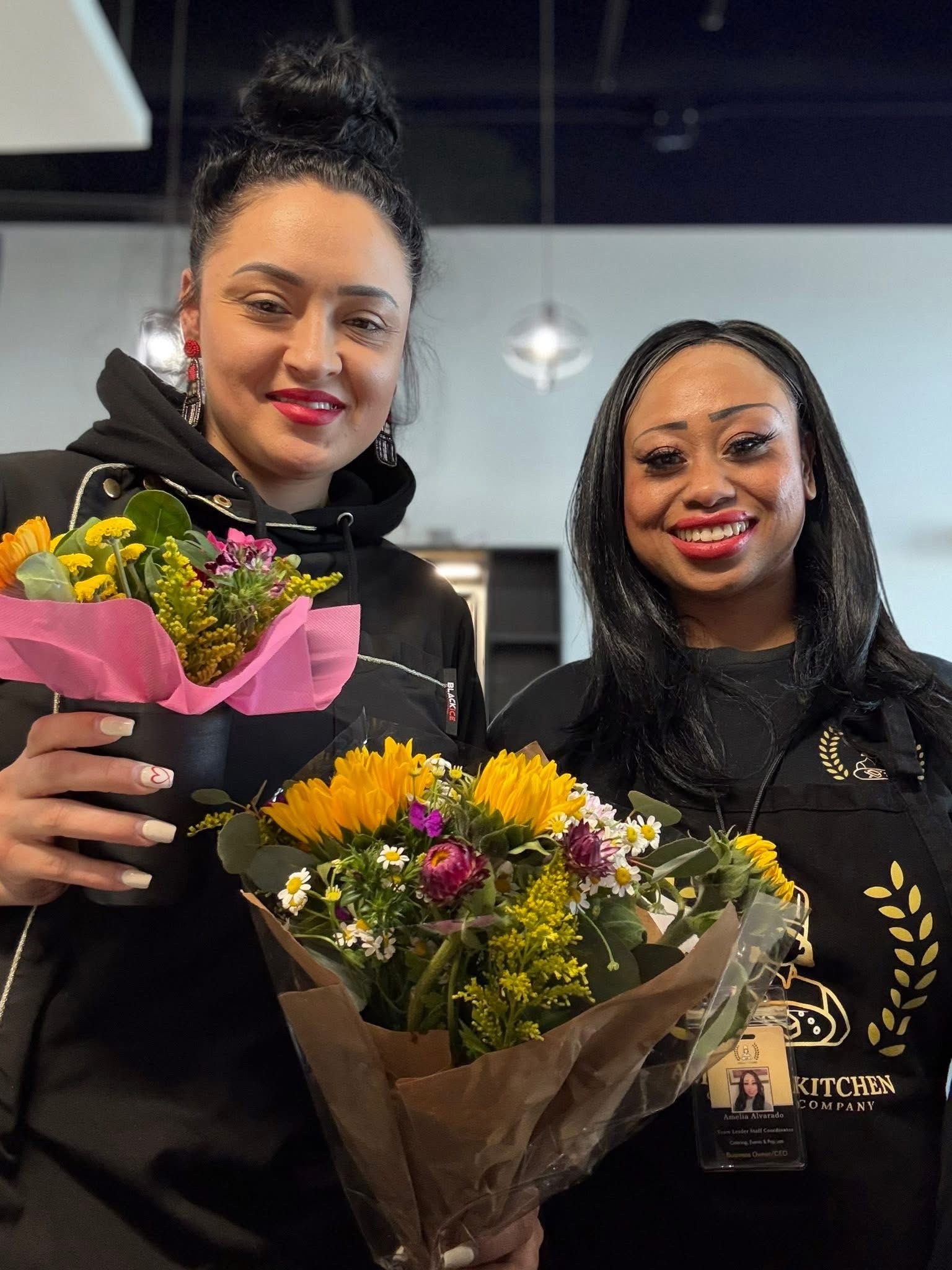 Chef Amelia with a customer holding flowers during Customer Appreciation Day
