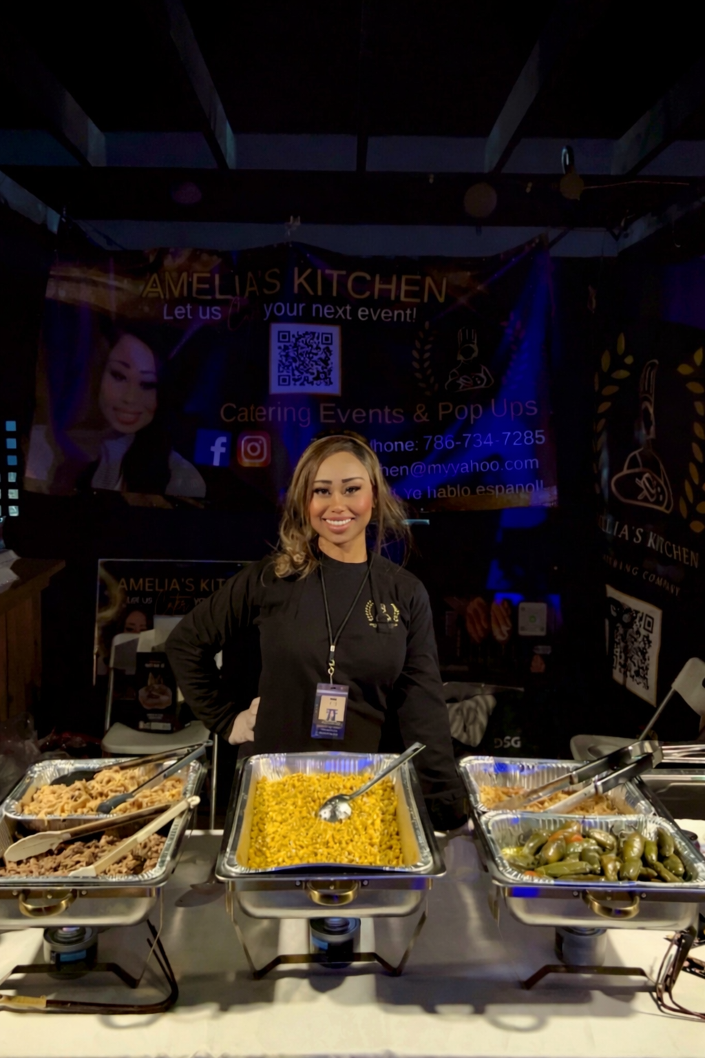 Chef Amelia behind catered chafing trays at an event