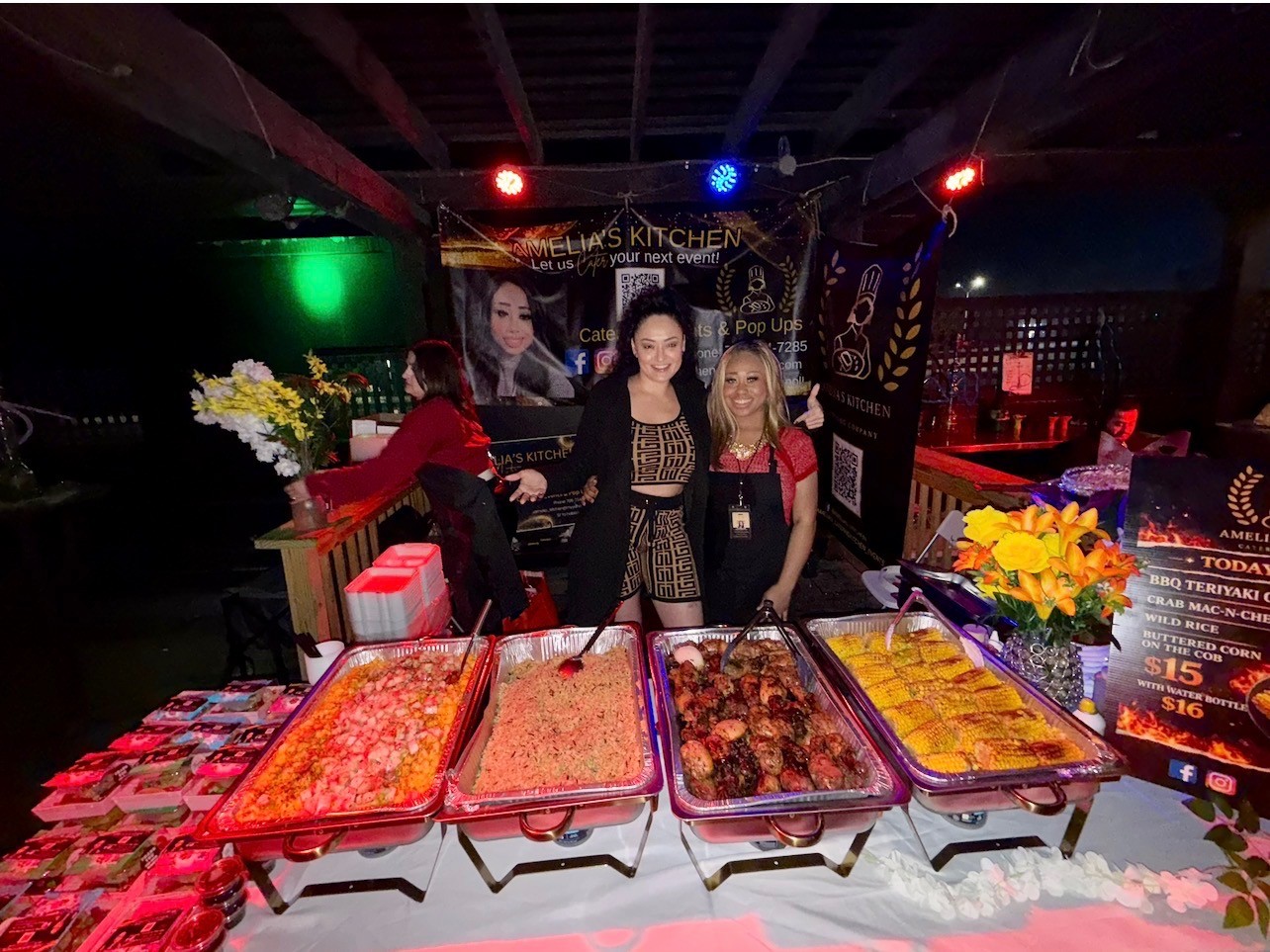 Amelia's Kitchen team serving food from a catered pop-up buffet